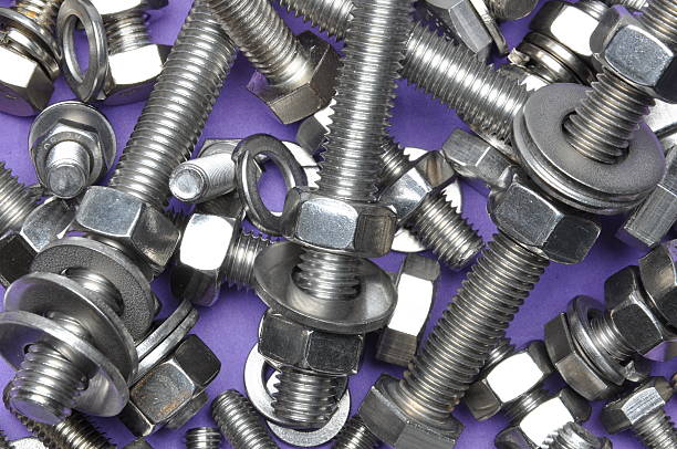 istock Bolts and nuts on violet background 494991580