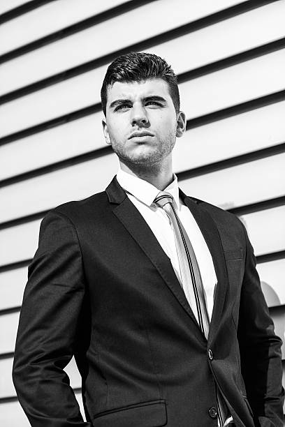 istock Young businessman near a office building wearing black suit 494992144
