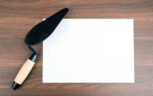 Blank card with palette-knife on wooden table