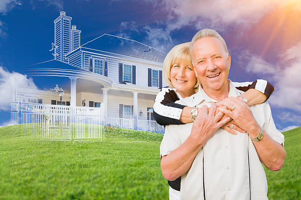 istock Senior Couple In Front of Ghosted House Drawing on Grass 494993130
