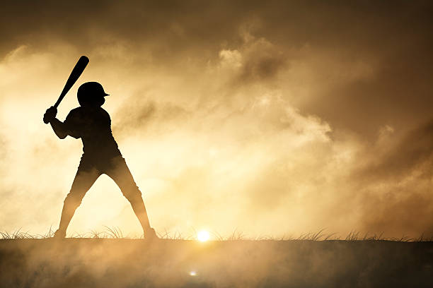 silhouette di un giovane giocatore di baseball - baseball player baseball men softball foto e immagini stock