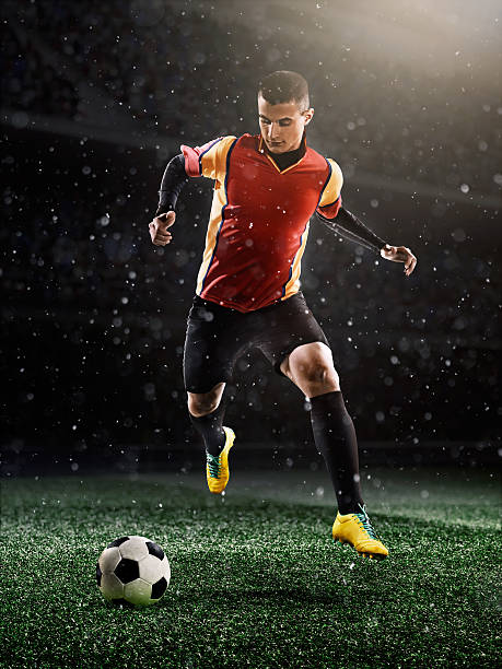 istock Soccer player kicking ball in stadium 494994698