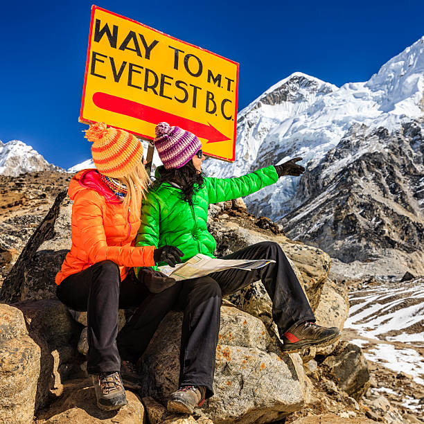 istock Young women studying map next to signpost, Nepali Himalaya 494995804
