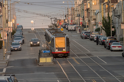 A group of light rail cars makes their way through San Francisco's Outer Sunset neighborhood.