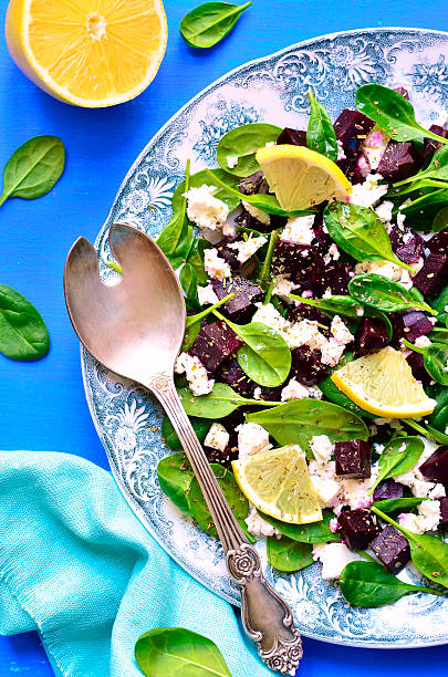 Spinach salad with beet root and feta cheese on a vintage plate.