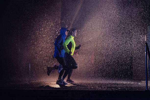 istock Joggers running on rainy night 494996650