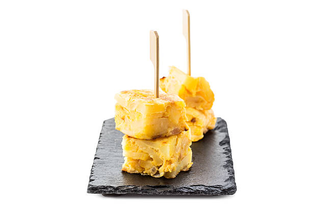 Potato omelette Spanish tapas. Tortilla de patatas toothpick isolated on white backround. tortilla de patatas stock pictures, royalty-free photos & images