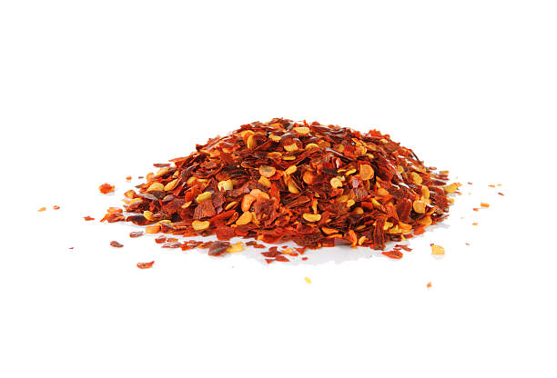 istock Pile of red pepper flakes on a white background 495005663