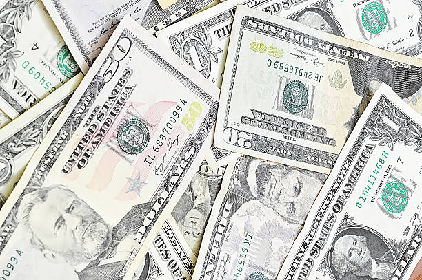 istock fifty, twenty, ten, five and one dollars isolated on white 495005901