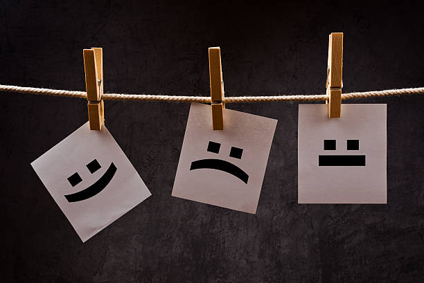 istock Emoticons on note paper attched to rope with clothes pins 495006407