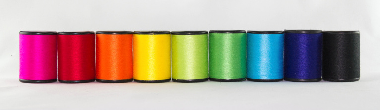 set of color threads on a white background