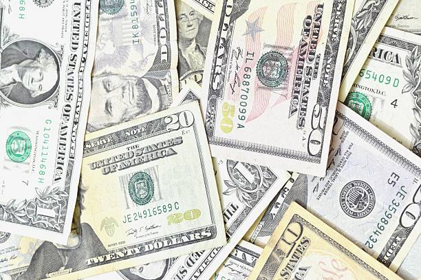 istock fifty, twenty, ten, five and one dollars isolated on white 495007923