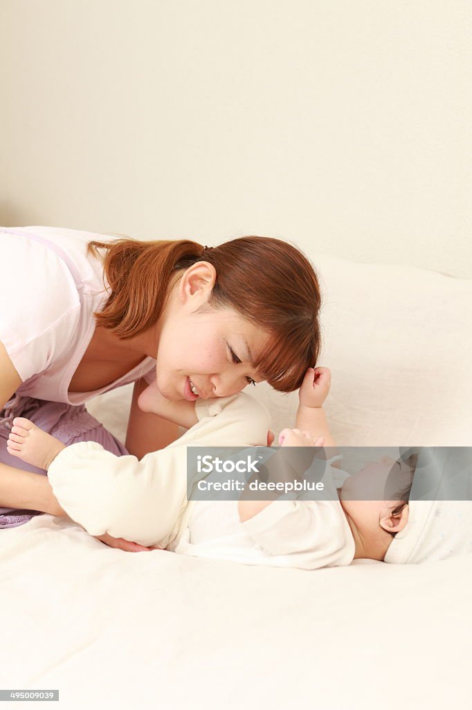 Diaper exchange Models are Japanese and actual mother and baby. Asian and Indian Ethnicities Stock Photo