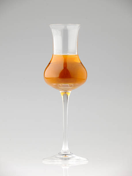 glass of holy wine on a mirrored neutral background