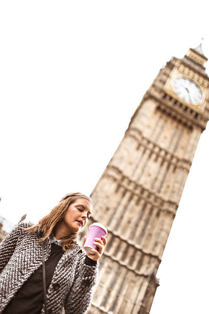 istock woman drinking a coffee on the street 495011171