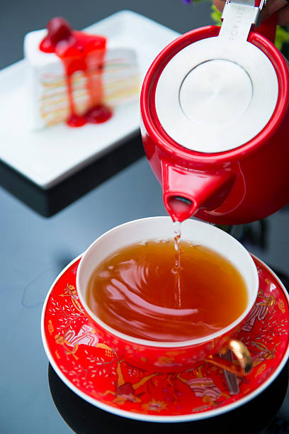 istock pouring hot tea in the red cup 495020754