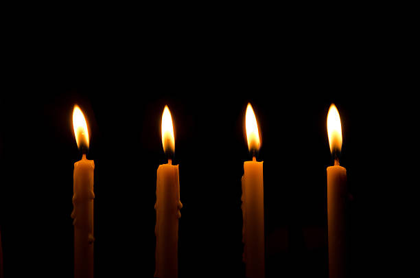 istock four light candle burning brightly in the black background 495023508