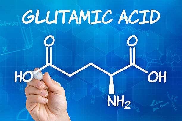 istock Hand with pen drawing the chemical formula of glutamic acid 495037954