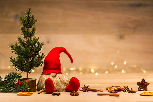 red christmas wretch next to fir tree and cinnamon sticks