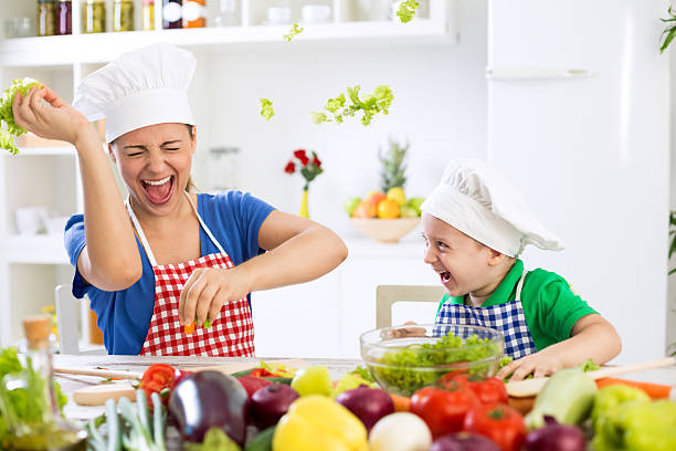 istock Mother and son have fun in kitchen food war 495040422