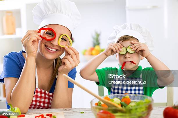 Happy Cute Family Have Fun In The Kitchen With Vegetables Stock Photo - Download Image Now