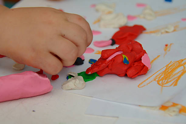 istock hand on the table moulding with color plasticine 495041488