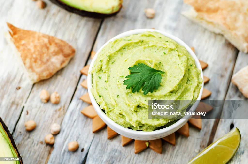 avocado hummus avocado hummus on a white wood background. toning. selective focus 2015 Stock Photo