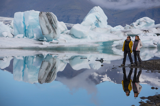 two women visit the famous glacier lagoon in the south east of iceland
