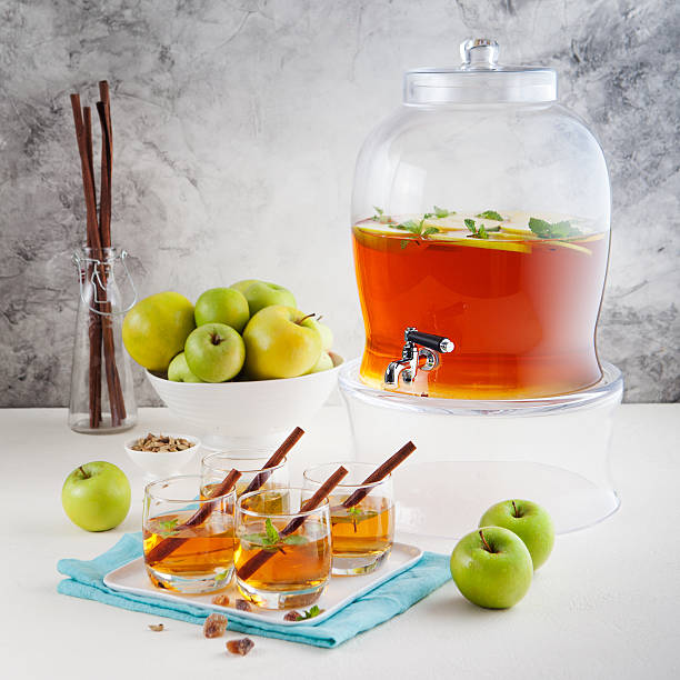 istock Apple, white wine punch, tea, mulled cider in beverage dispenser 495050216