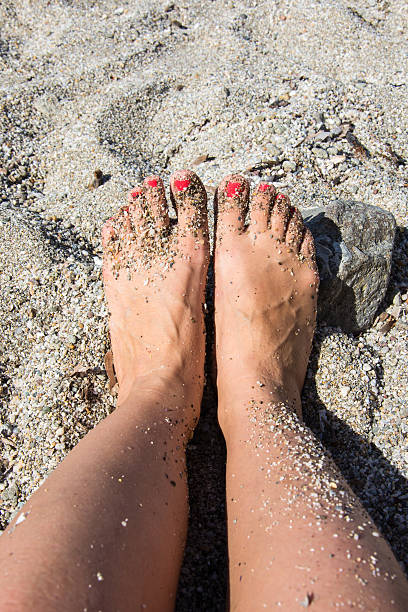istock Female feet on the sandy beach. 495052100