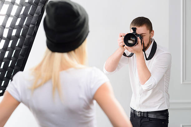 istock Young male cameraman during genuine work 495053766