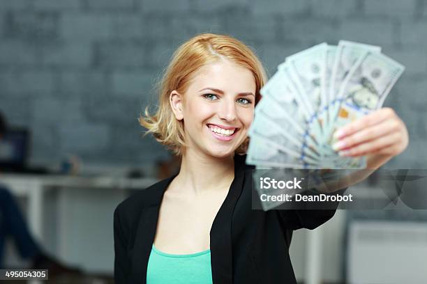 Businesswoman Holding Bills Of Dollars In Office Stock Photo - Download Image Now - Adult, Adults Only, Beautiful People