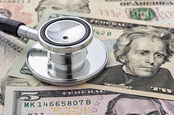 istock Close-up of a stethoscope on dollar bills 495054312