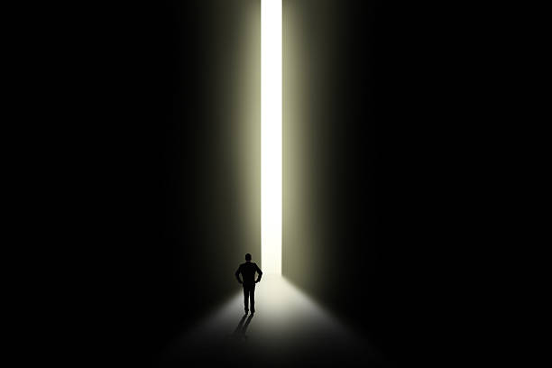 istock Businessman looking at light in doorway 495054947
