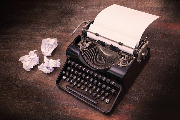 istock Vintage typewriter and old books 495055181
