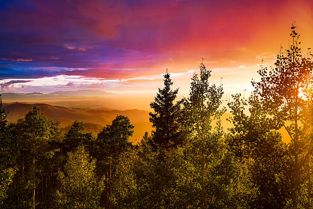 Multicolored Sunset Amazing sunset over the Santa Fe Ski Basin featuring red, orange, blue, yellow, and other colors in the sky santa fe new mexico mountains stock pictures, royalty-free photos & images