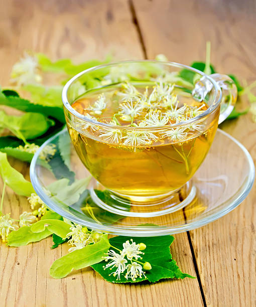 istock Herbal tea from linden flowers in glass cup on board 495056565