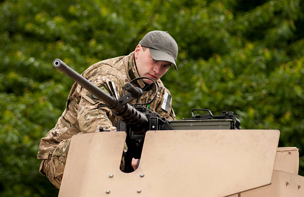 Unidentified soldier with machine gun Szczecin, Poland - Mai 29, 2014: Veterans Day in Poland. Unidentified soldier with machine gun.He is thoughtful and looking ahead. special forces vietnam stock pictures, royalty-free photos & images