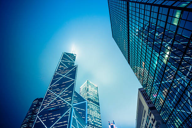 corporate buildings of hong kong corporate buildings in financial district of hong kong at night. the bank of china tower stock pictures, royalty-free photos & images