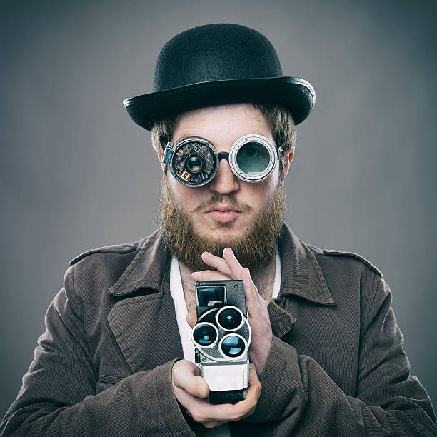 istock Bearded man with his old fashioned smart glasses holding camera 495061897