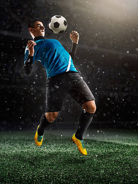 istock Soccer player kicking ball in stadium 495063978