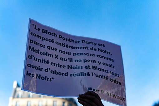 Paris, France - October 31, 2015: Banner about Black Panther party and Malcolm X during the anti racism event 