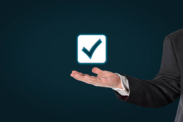 istock Businessman holding a virtual checked symbol 495064544