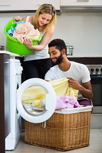 istock Interracial couple doing laundry at home 495065972
