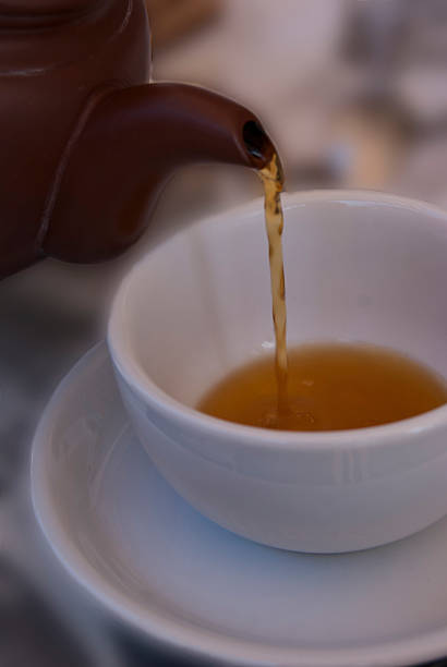 istock White cup of tea and a tea pot 495066078