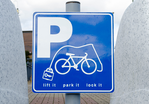 Blue and white bicycle parking sign lock it or loose it, Essex, UK.