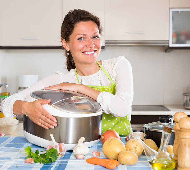 istock Woman cooking with multicooker 495067552