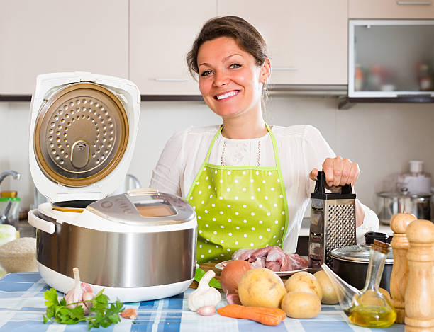 istock Woman cooking with multicooker 495067610