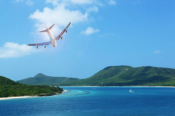 istock passenger plane flying over beautiful blue ocean 495070714
