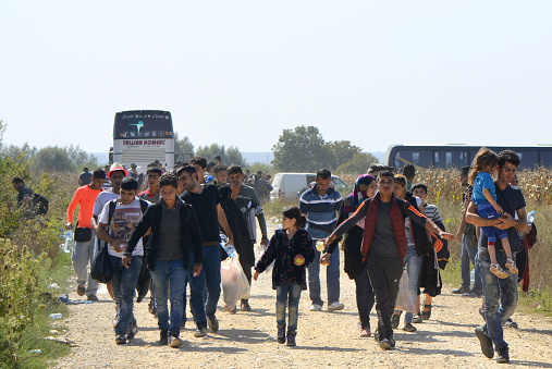 Sid, Serbia - September 18th, 2015: Syrian refugees getting off the bus and goin from Serbia towards Croatia, on theri way to European Union. Photographed at the bordere Serbia-Croatia, refugees goint toward Tovarnik 